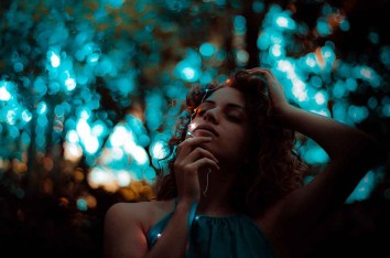 A girl with some some Christmas light and a blurred out background