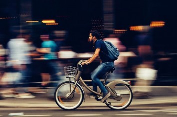 Panning shot of a man on a bike