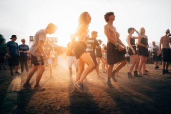 A group of people enjoying themselves in the evening outside