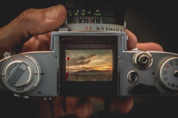 looking through the viewfinder of a film camera